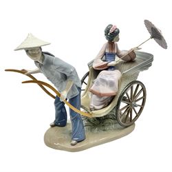 Lladro figure group, Rickshaw ride, modelled as a gentleman in blue dress pulling a rickshaw carrying a lady with a parasol, no 1383, H30cm