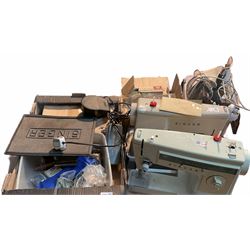 Two Singer sewing machines, model numbers 527 and 457, together with various Singer sewing machine parts, and a selection of sewing related accessories, to include threads, sewing needles, etc.
