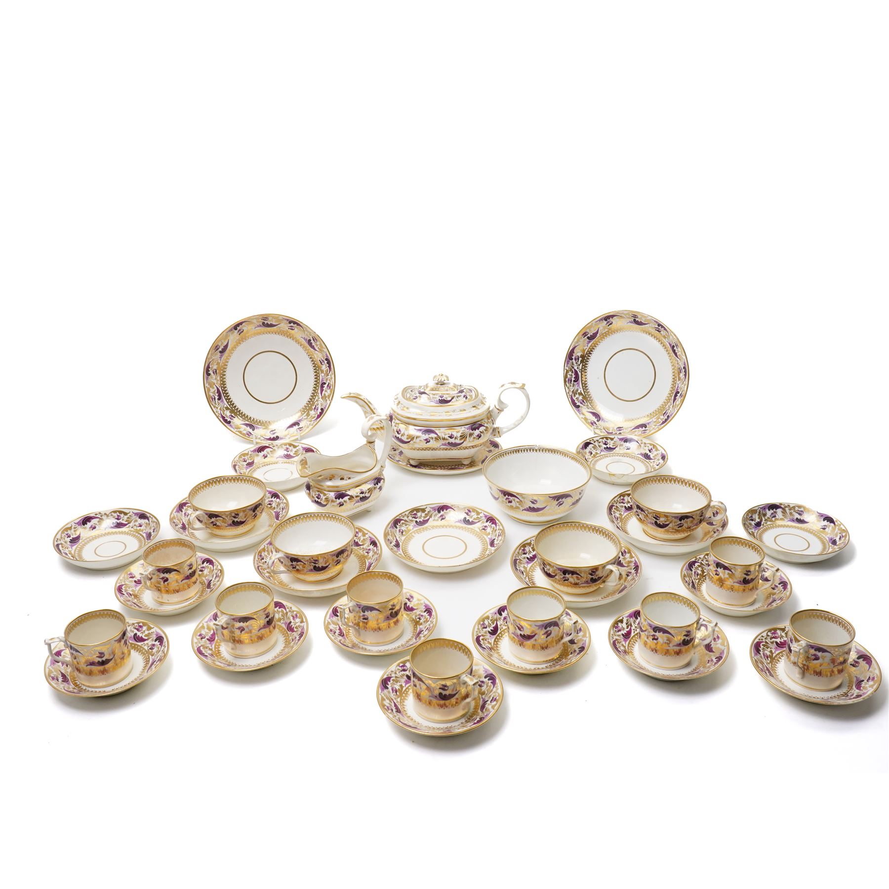 Early 19th century Derby tea and coffee service painted with a border pattern of purple and gilt leaves and flowers comprising four large cups with five saucers, nine coffee cans with twelve saucers, tea pot and stand, slop bowl, milk jug and two plates, red painted mark.