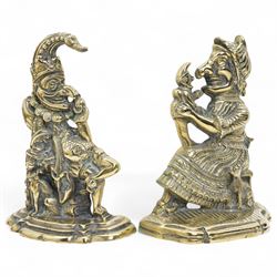 Early 20th century brass 'Mr Punch' doorstop H29cm, another 'Judy' H28cm, pair of brass Jack of Diamonds brass candlesticks H36cm, two other candlesticks and a chamber stick (7)
