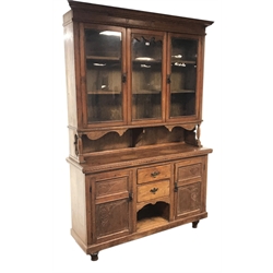  19th century pine bookcase on cupboard, projecting cornice, two glazed doors enclosing three shelves, two cupboards, two drawers, W158cm, H231cm, D46cm  