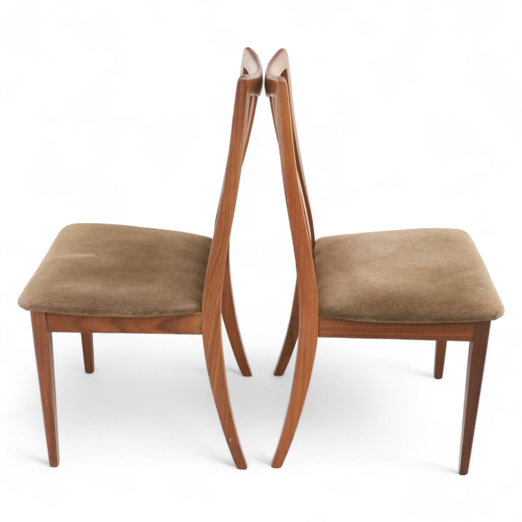 G Plan - mid-20th century teak extending dining table, oval top with integrated extension leaf, raised on tapering legs, together with a set of six slat back dining chairs including two carvers, upholstered in dark green velour (Extends to 210cm)