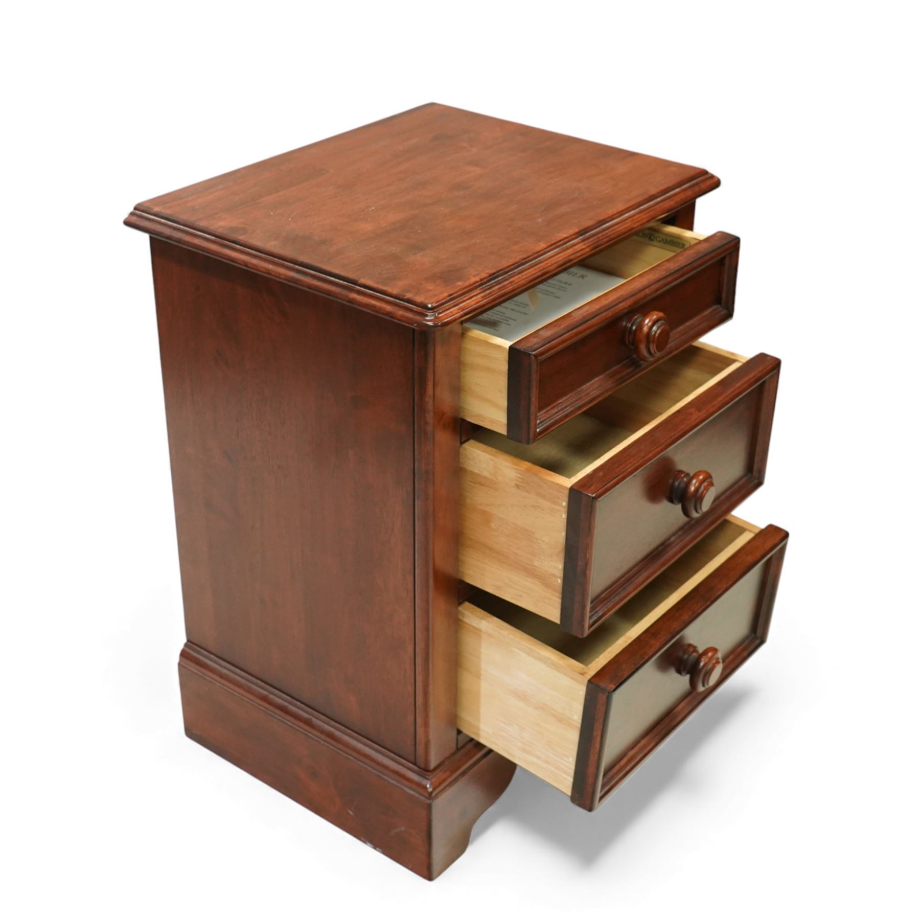 Willis & Gambier - three-drawer lamp chest, rectangular moulded top over three framed drawers with turned wooden knobs, raised on a shaped plinth base