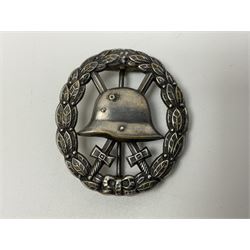 Four German awards - pre-WW2 two-position button hole ribbon for 1914 Iron Cross; WW1 wound badge open back cut-out version with silvered finish; miniature version Mother's Cross with ribbon bow; and The Eastern Medal, officially the Winter Battle in the East 1941–42 Medal (4)