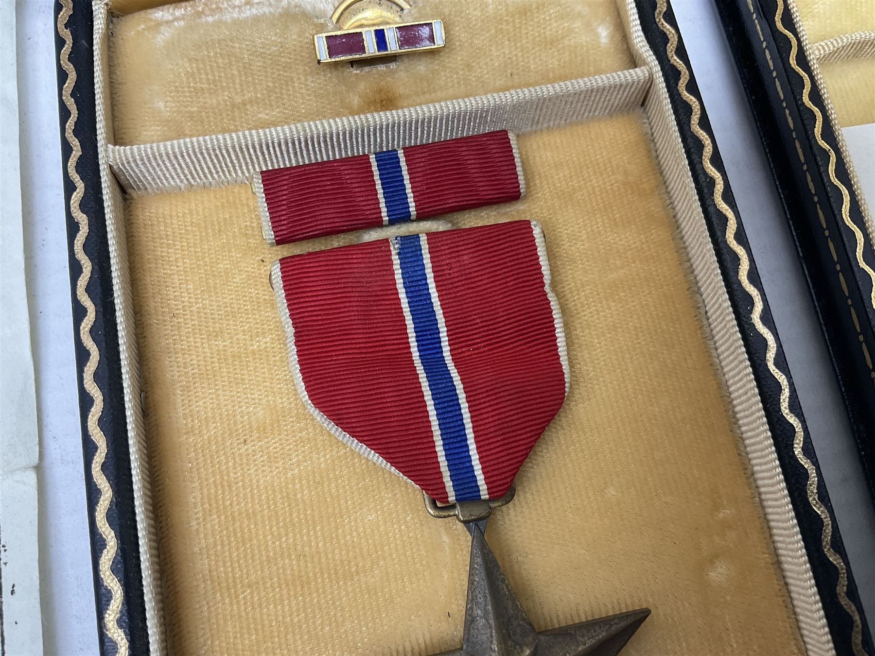 American Purple Heart Medal awarded to 32634848 Charles H. Poppo; cased with identity tags and paperwork; and Bronze Star Medal awarded to U.S. Marine Esteban T. Maranao; cased; American WWII Victory Medal and Asiatic Pacific Campaign Medal