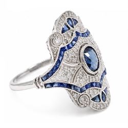 Platinum sapphire and diamond dress ring, milgrain set with a single oval cut sapphire, surrounded by single cut diamonds, calibre and vari-cut sapphires, in an pierced design setting, stamped PT 950, total sapphire weight 0.87 carat, total diamond weight 0.45 carat