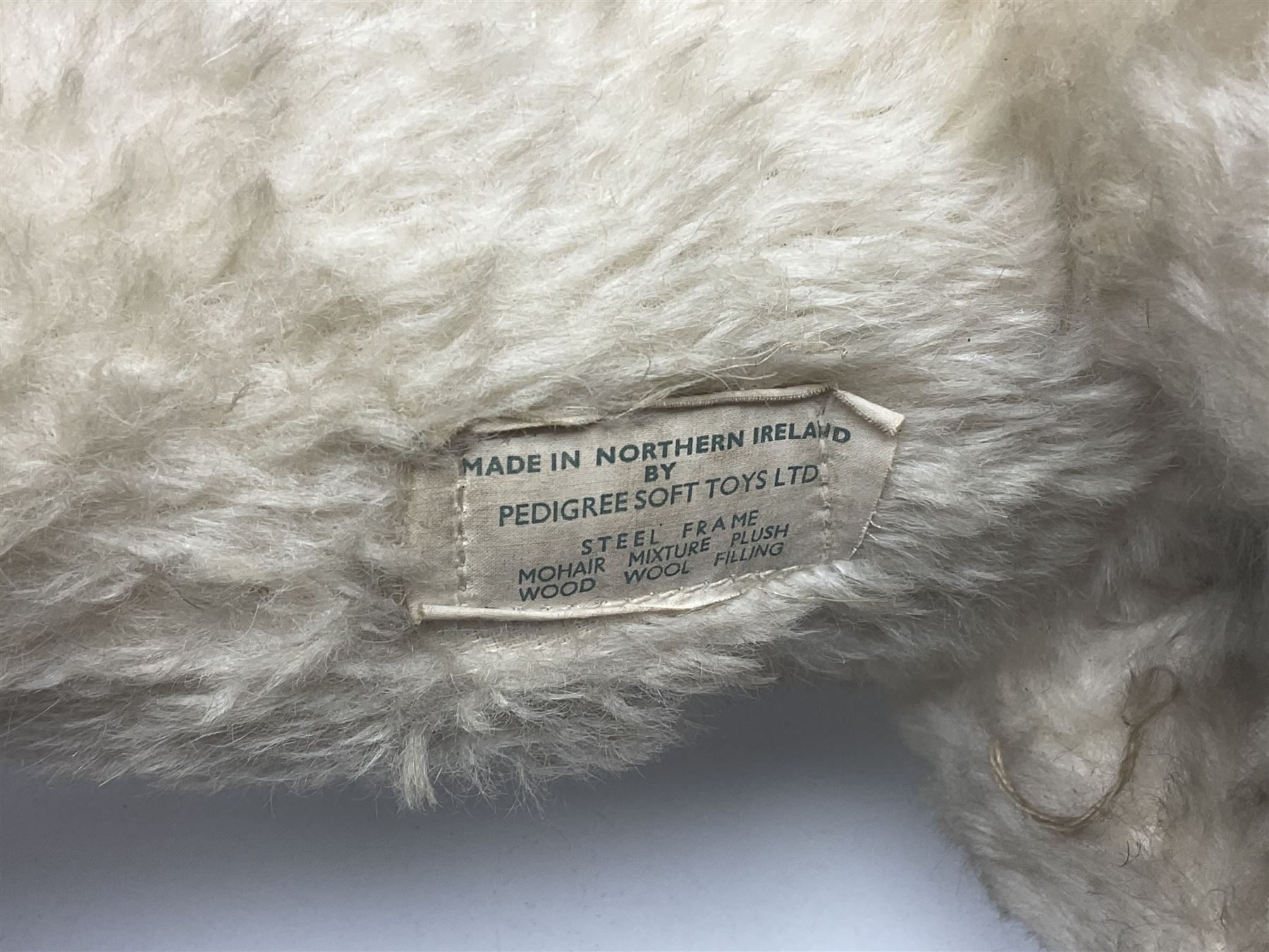 Tri ang - Pedigree Soft Toys - push along/ride-on dog as a wood wool filled plush Airedale terrier in red tubular frame with beech footrests and black rubber wheels; stitched Northern Ireland label in tact L60cm H61cm