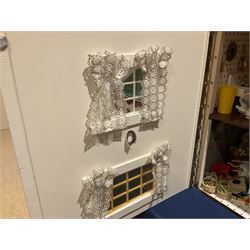 Seagull Pub - scratch-built wooden doll's house as a two-storey gable fronted public house painted in white green and maroon; the hinged front with ground floor veranda and window over opening to reveal two fully furnished rooms with dog-leg staircase and well stocked bar with bar-tender L31cm H62cm D37cm; together with Corner Shop and Dollies Pantry; a similarly painted scratch-built wooden two-storey flat-roofed doll's house as a well stocked ground floor grocery shop with stairs up to two further fully furnished rooms and more stairs giving access to a roof terrace L46cm H57cm D33cm (2)