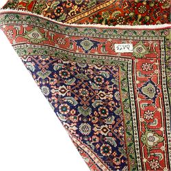 Persian Hamadan red ground rug, the field decorated with Herati motifs, multiple band border with repeating floral design