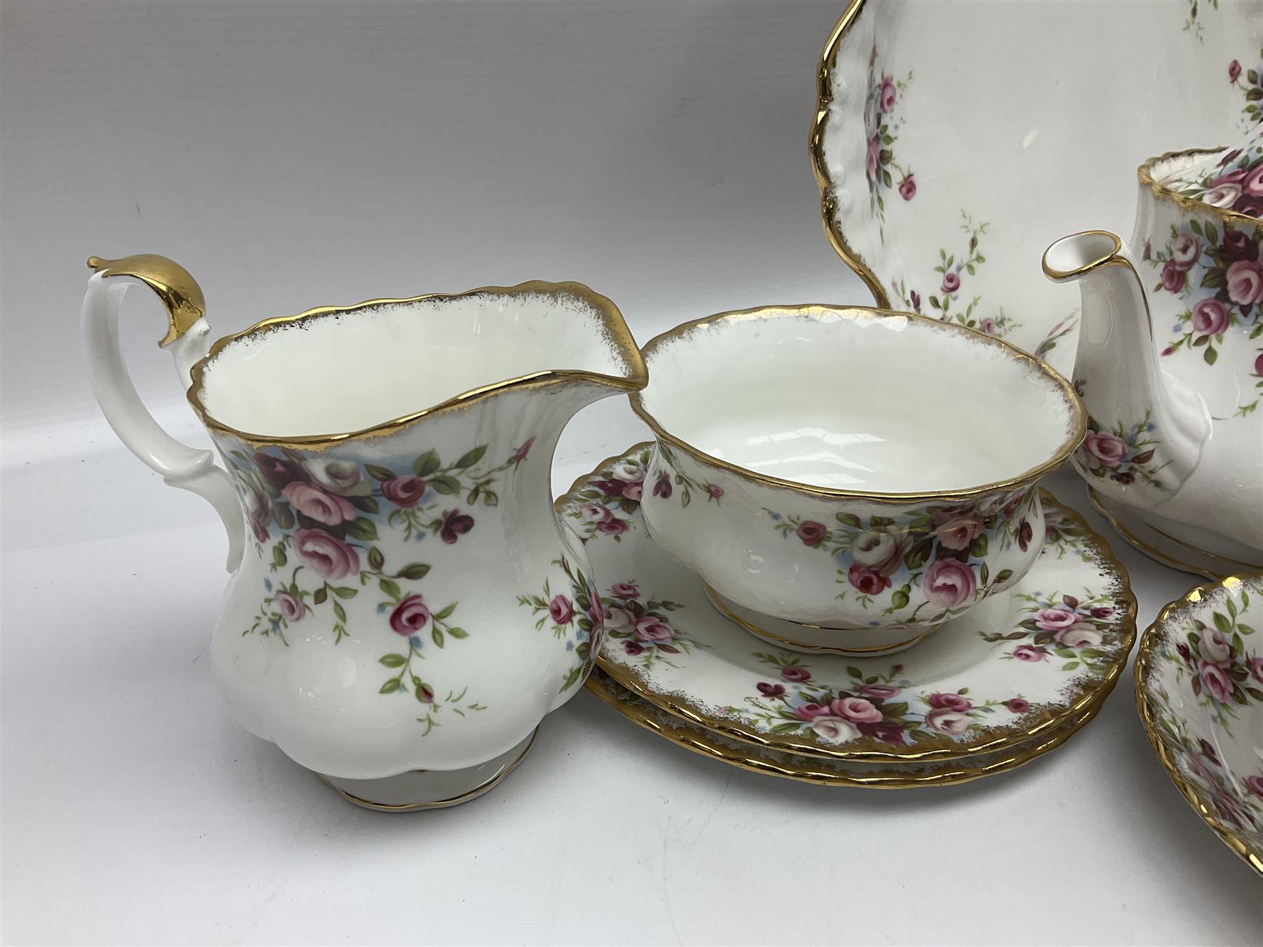 Royal Albert Cottage Garden pattern tea service for six people, comprising teapot, milk jug, sugar bowl, teacups and saucers, side plates and cake plate, all with printed mark beneath