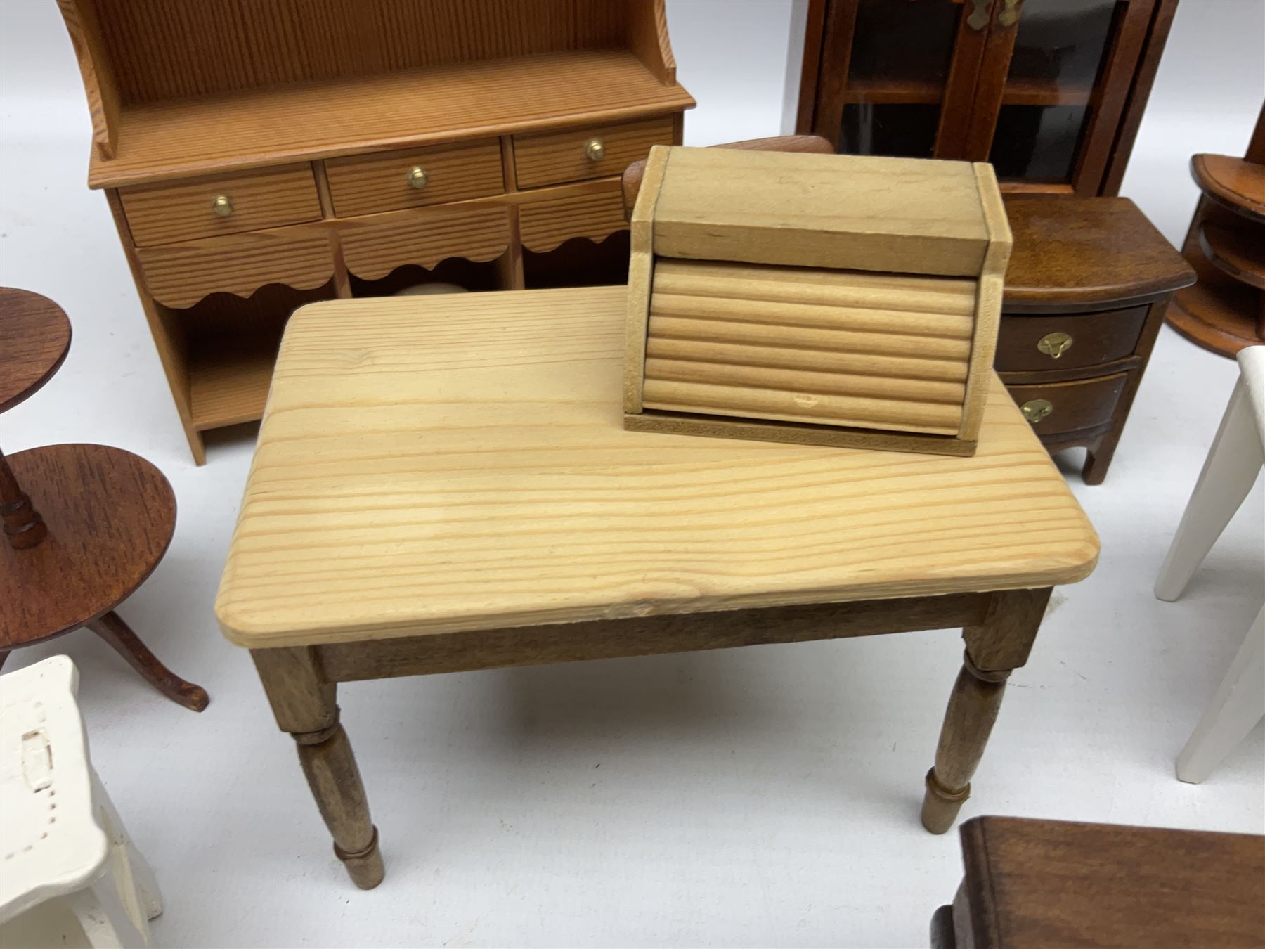 Doll's house wooden furniture - over twenty items including good quality pine Welsh dresser by Tony of Lincoln; tall 'glazed' bookcase; two-tier side cabinet; grand piano; bedside chest, mule chest, Canterbury; cradle; Georgian style hanging corner cupboard; dumb waiter; tables; chairs; rocking chair etc; various scales