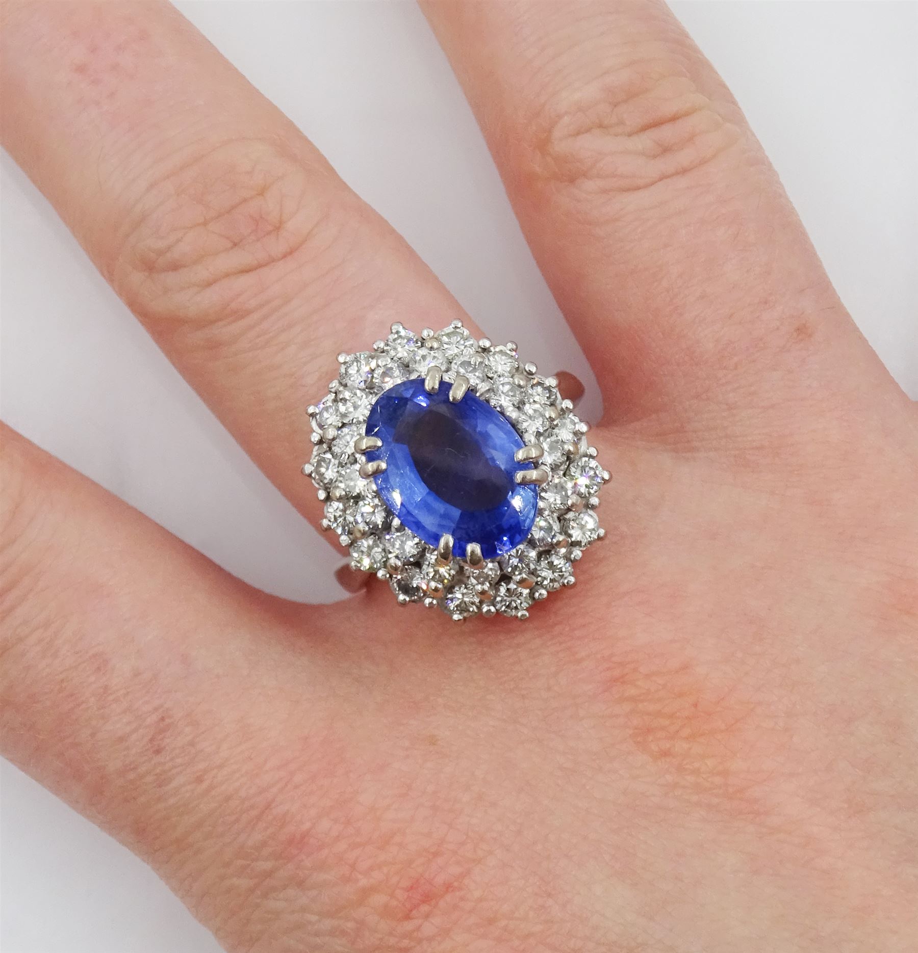 18ct white gold oval sapphire and round brilliant cut diamond cluster ring, Sheffield 2000, sapphire approx 3.75 carat, total diamond weight approx 0.70 carat