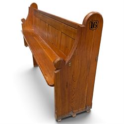 Early 20th century stained pine ecclesiastical church pew, the shaped end supports flanking slatted and panelled back, with black stencilled number '16' to the side