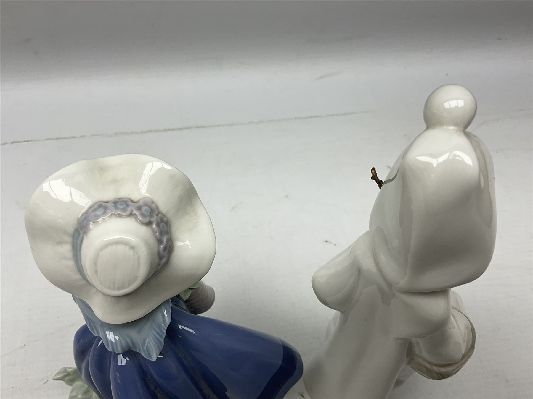 Four Lladro figures, comprising Pulling Dolls Carriage no 5044, Belinda with her Doll no 5045, Pretty Pickings no 5222 and Shepherdess with basket no 4678 