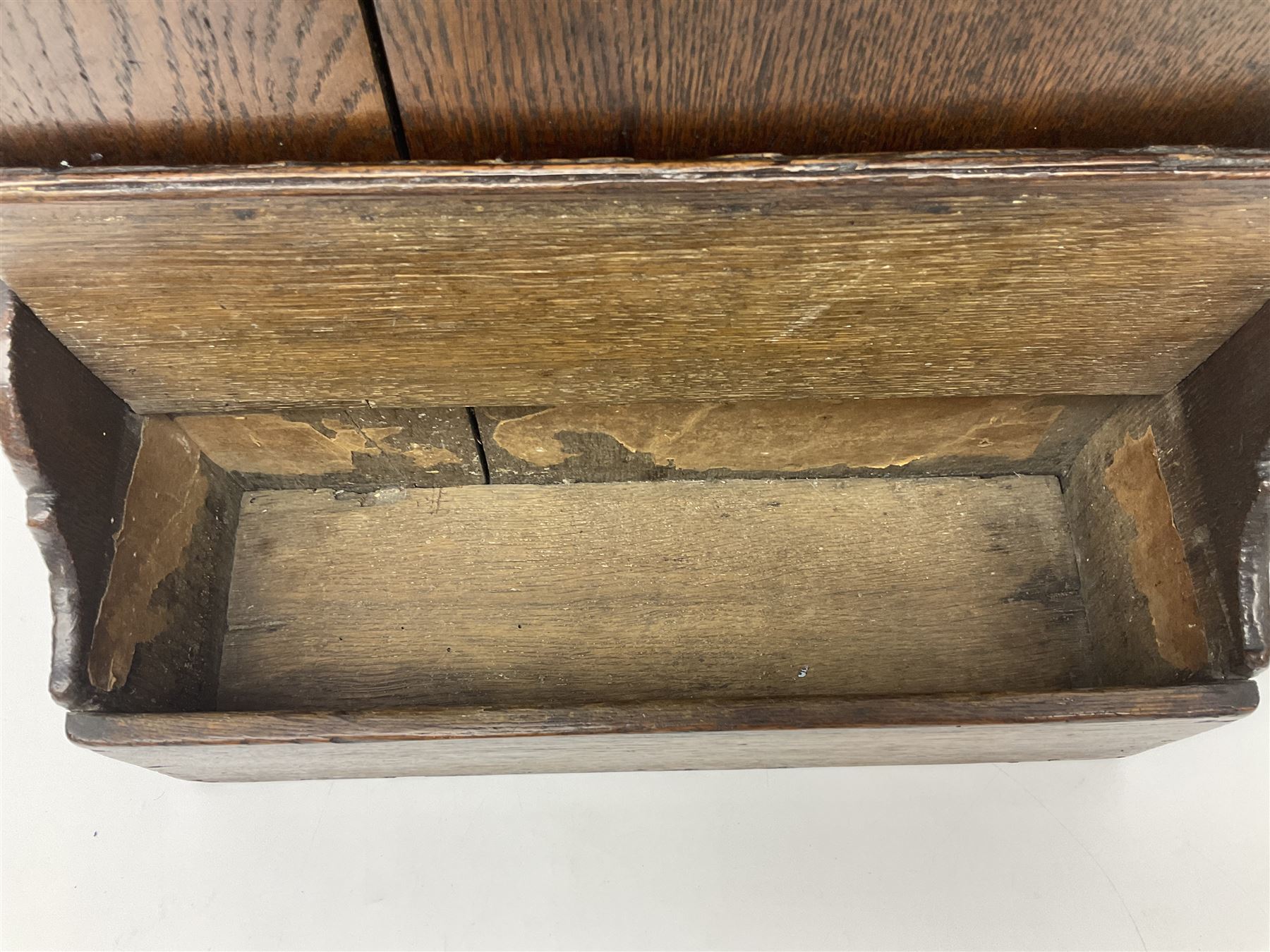 George III oak spoon rack and candle box, the rectangular backplate with shaped  pediment and two six aperture spoon racks, above a candlebox with hinged cover, with various brass spoons and a pair of brass candle snuffers, H56.5cm, W35cm, D14cm 