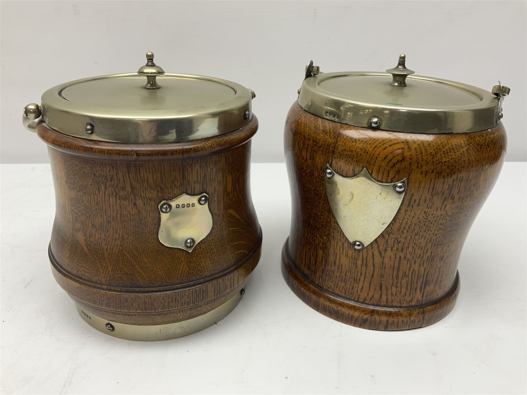 Five early 20th century biscuit barrels with silver-plated mounts, one made from Mahogany from HMS Hindustan