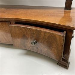 An early 20th century figured mahogany toilet mirror, the oval swing mirror above a serpentine front fitted with three drawers, on ogee bracket feet, H63cm L71cm. 