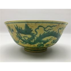 Pair of Chinese famille jaune bowls, decorated in green enamel with a dragon chasing a flaming pearl amongst clouds, upon a yellow ground, the interior decorated to centre with dragon, with six character mark beneath, D17.5cm