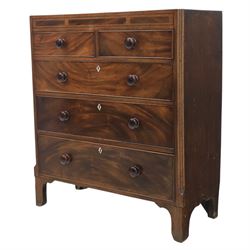 Early 19th century mahogany chest, straight front with canted corners, featuring inlaid detail above two short and three long drawers with flame veneered facias