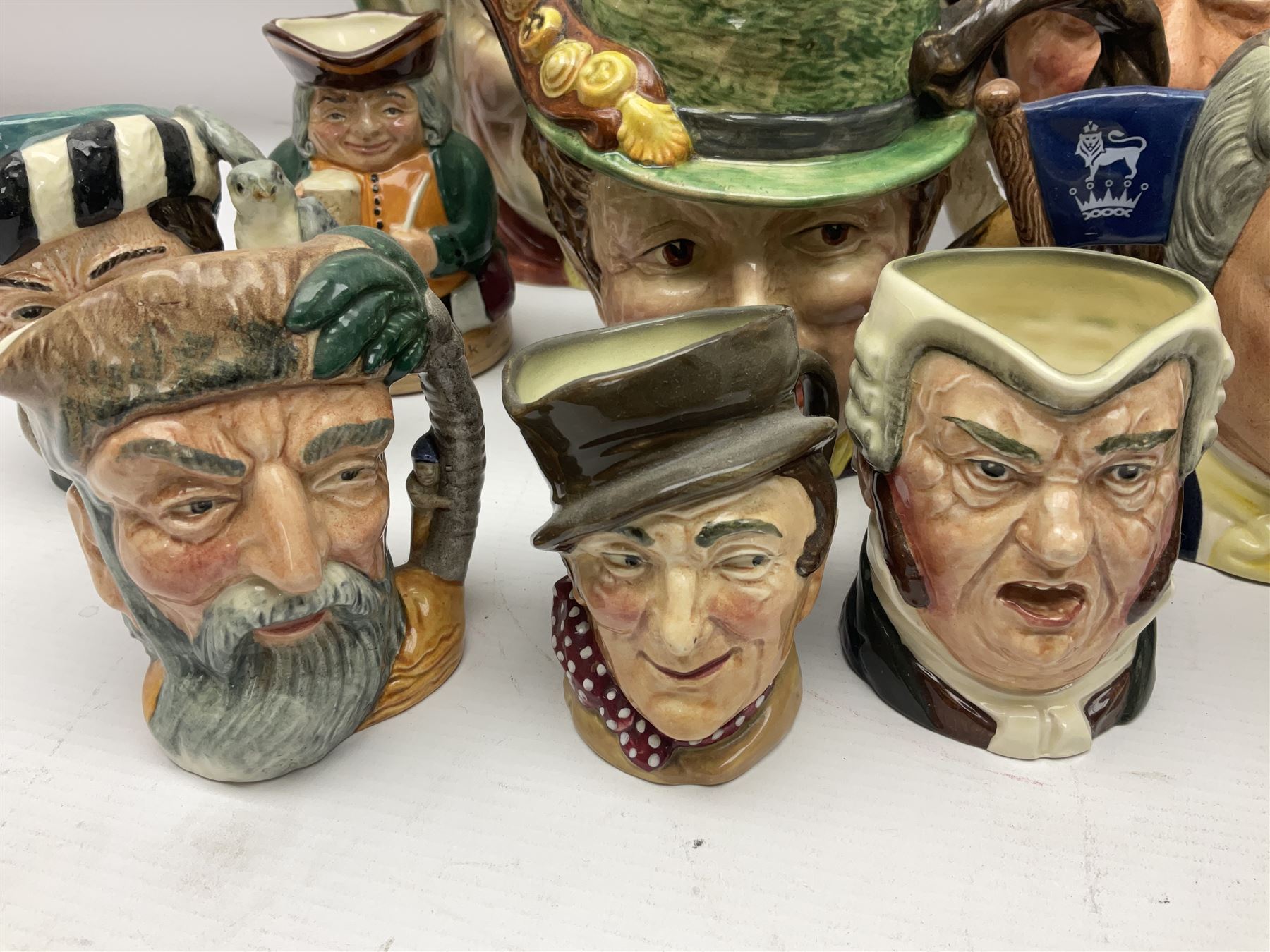 Collection of Royal Doulton and Beswick character jugs of various sizes, including North American Indian D6611, The Falconer D6533,  Tony Weller 281, Sairey Gamp 371 etc