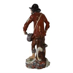 Mid 18th century Furstenberg figure, modelled as a beggar or mendicant with peg leg and bare foot, circa 1755, modelled by Simon Feilner, wearing tattered clothes, one arm supporting an alms pouch, the other holding a crutch, upon a part scrolled base, bearing paper labels beneath including one inscribed 'Sammlung Wilhelm Gumprecht 322', H15cm