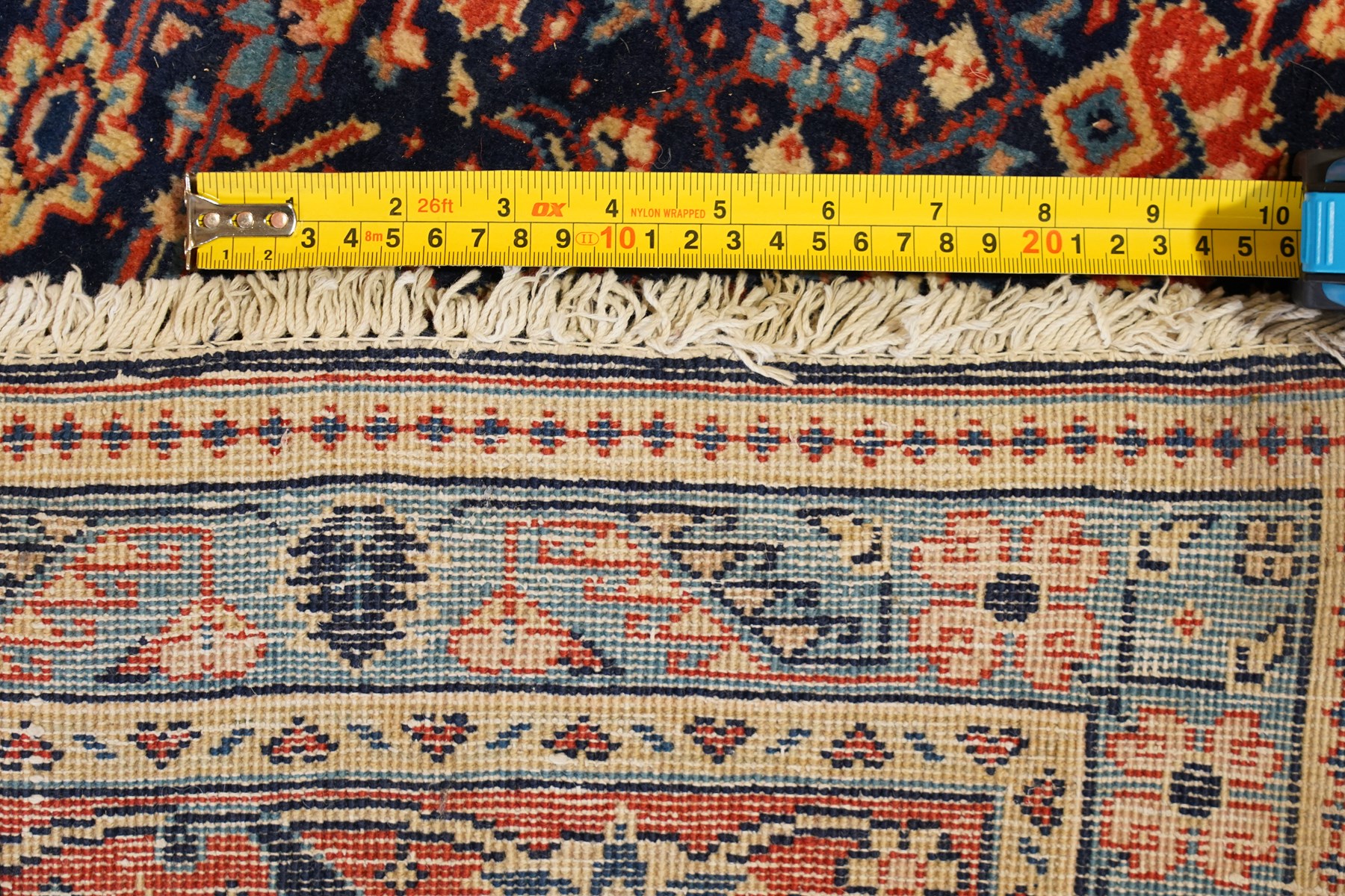 Persian indigo ground Herati rug, the busy field with a central lozenge pole medallion surrounded by repeating Herati motifs, within a shaped spandrel border the crimson guard band decorated with repeating palmette motifs