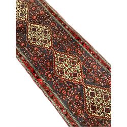 North West Persian pale indigo ground Senneh runner, the field decorated with seven linked medallions, decorated all over with Herati motifs, guarded border with trailing floral pattern