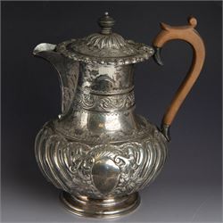 Victorian silver four piece tea service, comprising hot water pot, teapot, milk jug and sugar bowl, of circular part fluted bellied form, with embossed and engraved floral decoration, engraved with initials to body, the teapot and hot water pot with wooden handles and finials, hallmarked Z Barraclough & Sons, Sheffield 1898