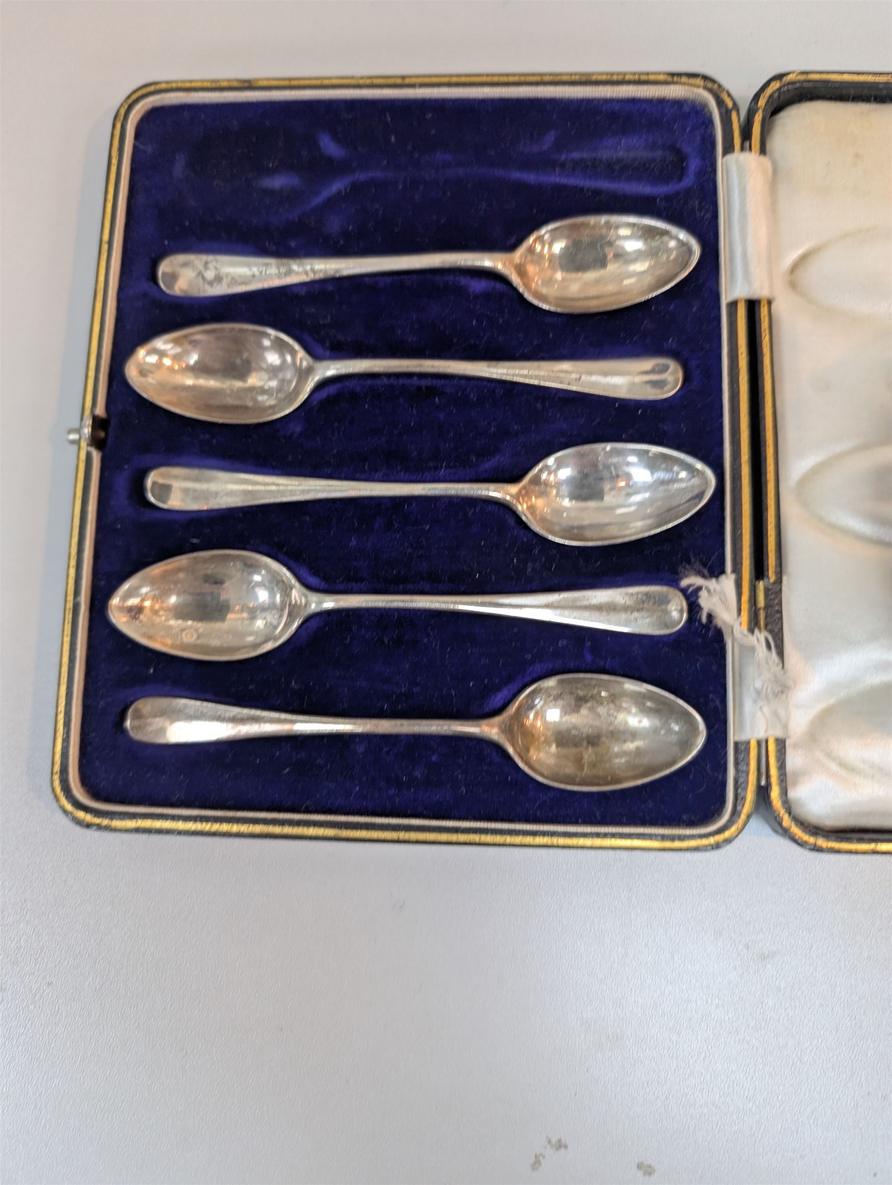 Scandinavian silver bowl, with embossed decoration upon three pad feet, stamped 830s, together with five cased silver coffee spoons, hallmarked, bowl H5cm