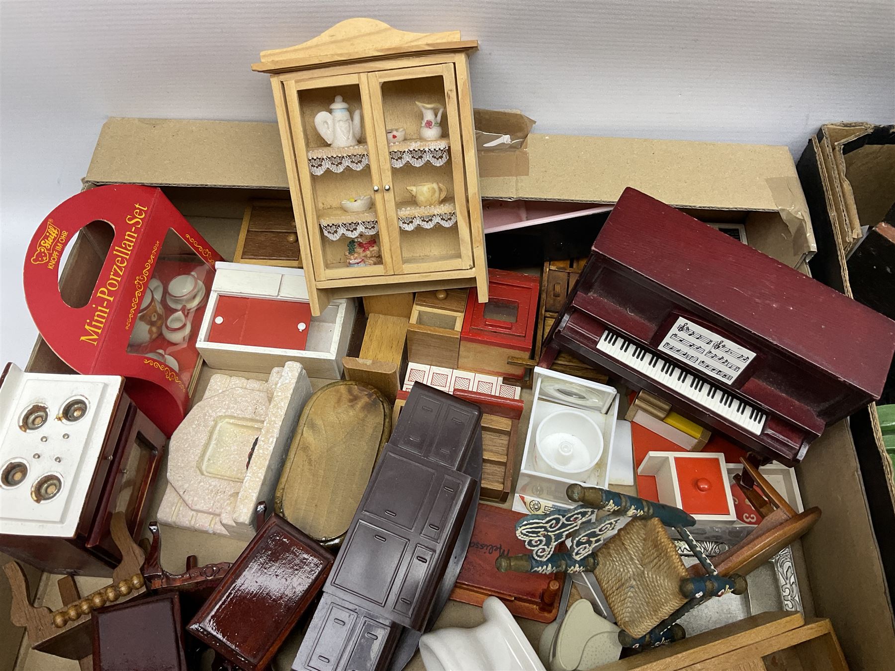 Large quantity of 1970s doll's house furniture, predominantly stained or painted wooden, including lounge, dining room, kitchen and bedroom pieces, bathroom fittings, bureaux and desks, piano, lamps, fire-surrounds etc; various scales