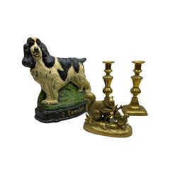 Cast iron doorstop modelled as a spaniel dog on grassy base, together with brass squirrel family group and pair of brass candlesticks