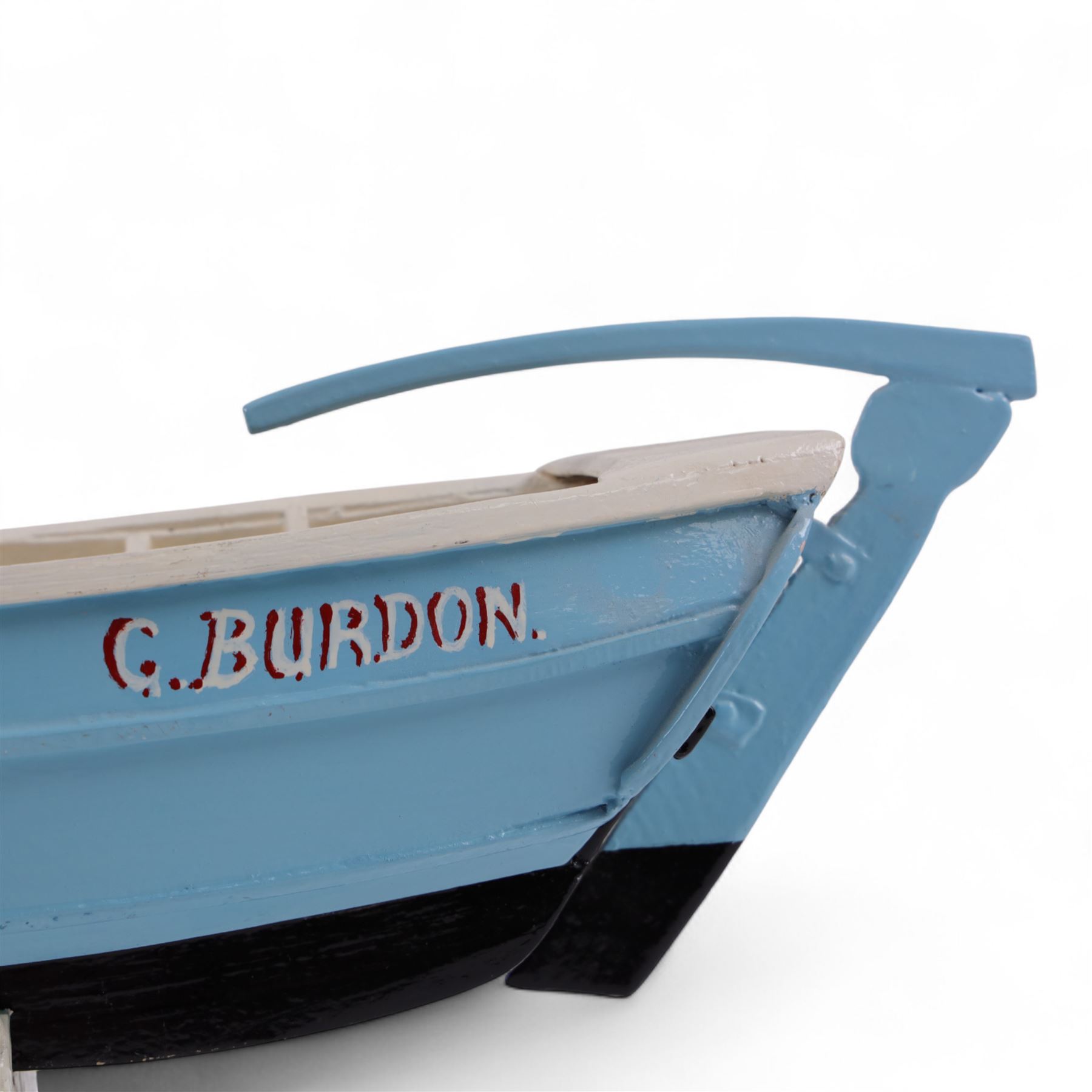 Wooden model of the Whitby fishing coble WY.17 G.Burdon 'Dorothy', painted in blue and white with red detail, with rudder and oars, on a painted wooden stand, L73cm, H20cm