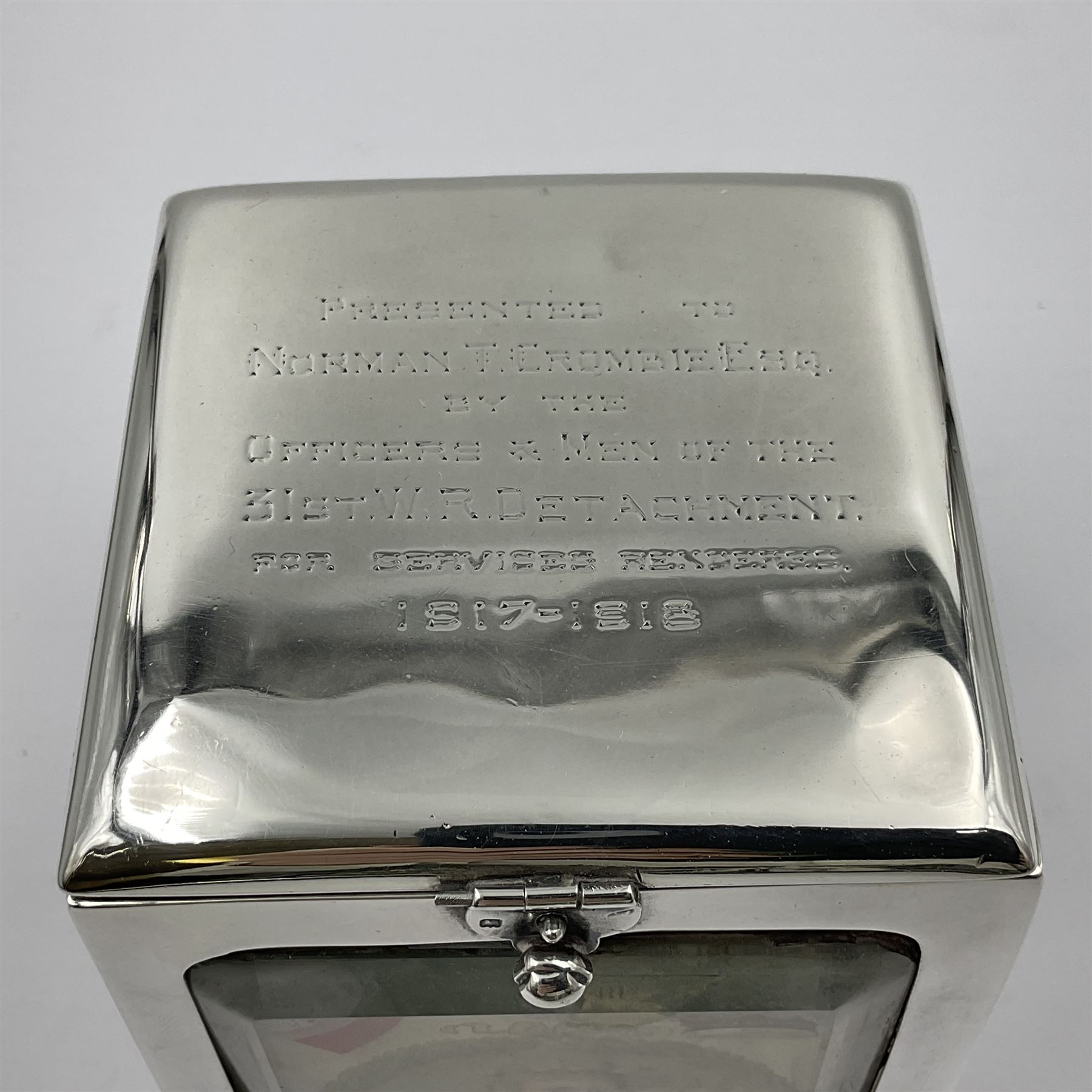 Edwardian silver mounted playing card case, hallmarked William Harrison Walter, Birmingham 1903, the sides each with a period playing card set behind a bevelled glass panel, the hinged cover with later engraving 'Presented to Norman T Crombie Esq by the officers & men of the 31st WR Detachment for services rendered 1917-1918', with red leather lined interior, the three compartments upon a sprung base and containing two later wooden Whist markers, case H12.5cm