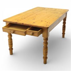 Late 20th century pine farmhouse dining table and four chairs, the rectangular plank top with rounded corners over two frieze drawers fitted with turned knob handles, raised on turned legs, the chairs with shaped ladder backs and turned finials, rush seats in a herringbone weave, on turned supports united by stretchers