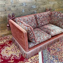 Knole type drop arm sofa with cushions in a traditional patterned upholstery,
