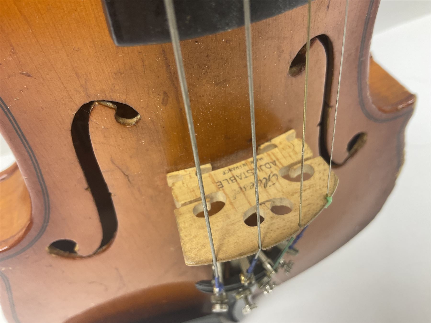 Four Chinese graduated violins - full size with 35.5cm two-piece back; three-quarter size with 33.5cm two-piece back; half size with 31cm two-piece back; and quarter size with 27.5cm two-piece back; all cased except full size; one with bow (4)