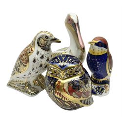 Four Royal Crown Derby paperweights, comprising Owl, Bee-eater, Song Thrush, and White Pelican all with gold stoppers 