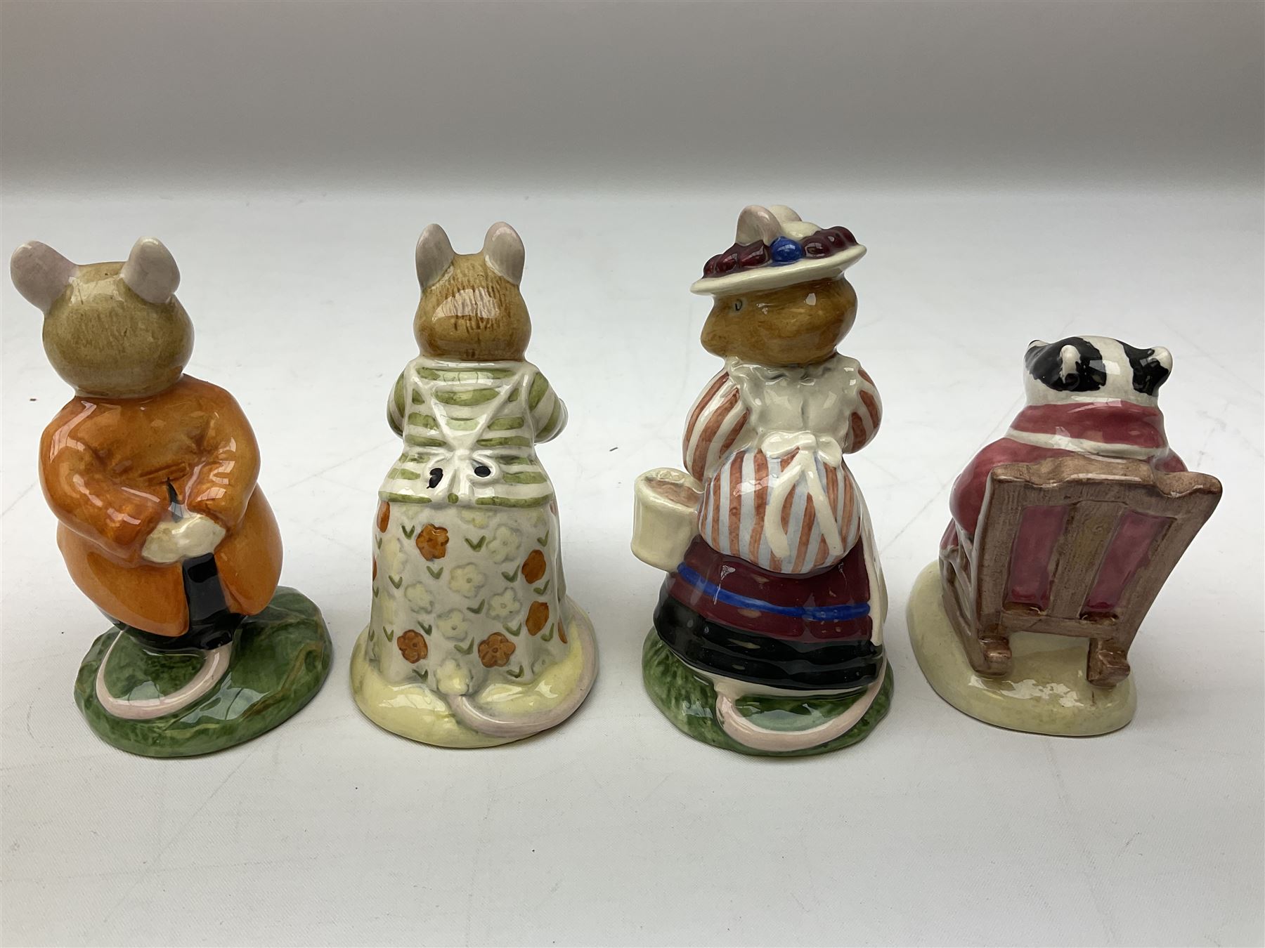 Fifteen Royal Doulton Brambly Hedge figures, comprising Wilfred Toadflax, Dusty Dogwood, Mrs Toadflax, Mr Apple, Primrose Woodmouse, Lord Woodmouse, Poppy Everbright, two Lady Woodmouse, two Old Mrs Everbright, Mr Toadflax, Mrs Apple, Santa Bunnykins and Bunnykins, together with three Royal Albert Wind in the Willows figures comprising Ratty, Badger and Mole, all with printed marks beneath (18)