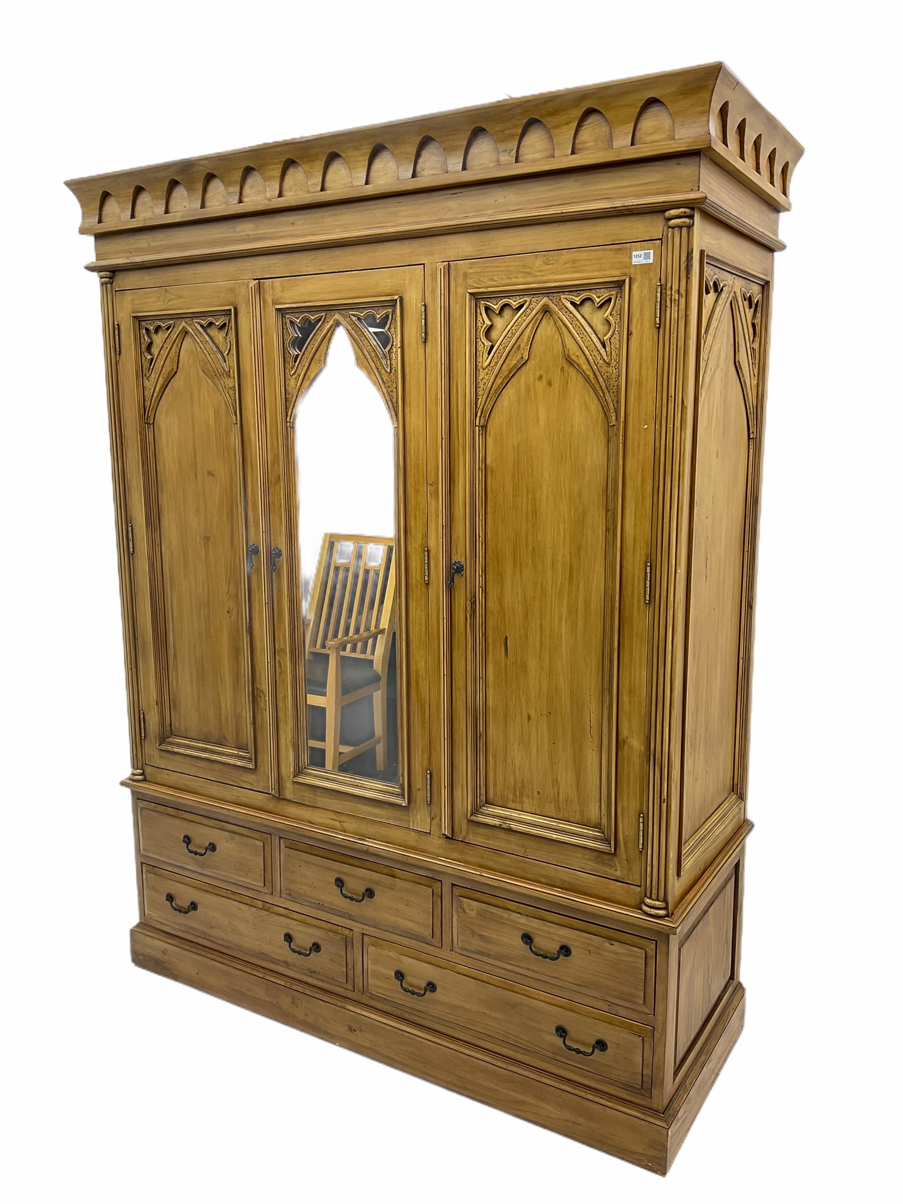 Gothic polished pine triple wardrobe, fitted with five drawers 