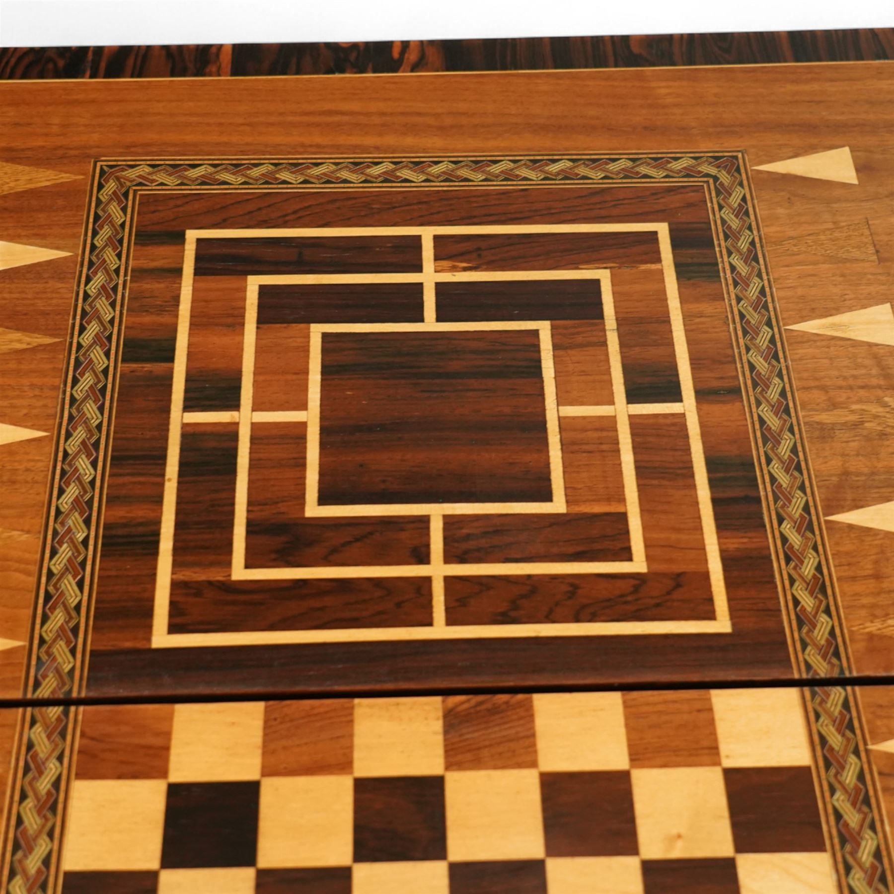 19th century mahogany fold-over card table, the crossbanded rectangular top opening to reveal an inlaid games centre with chessboard and backgammon designs, raised on turned and reeded legs with extending rear supports