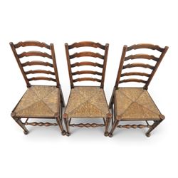 19th century set of six ash and elm ladderback dining chairs, shaped ladder backs above rush seats, raised on turned front supports with pad feet, united by turned stretchers