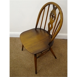  Set four Ercol medium elm hoop back chairs (W43cm) and an oval oak drop leaf dining table, turned gate leg supports (W137cm, H74cm, D115cm)   