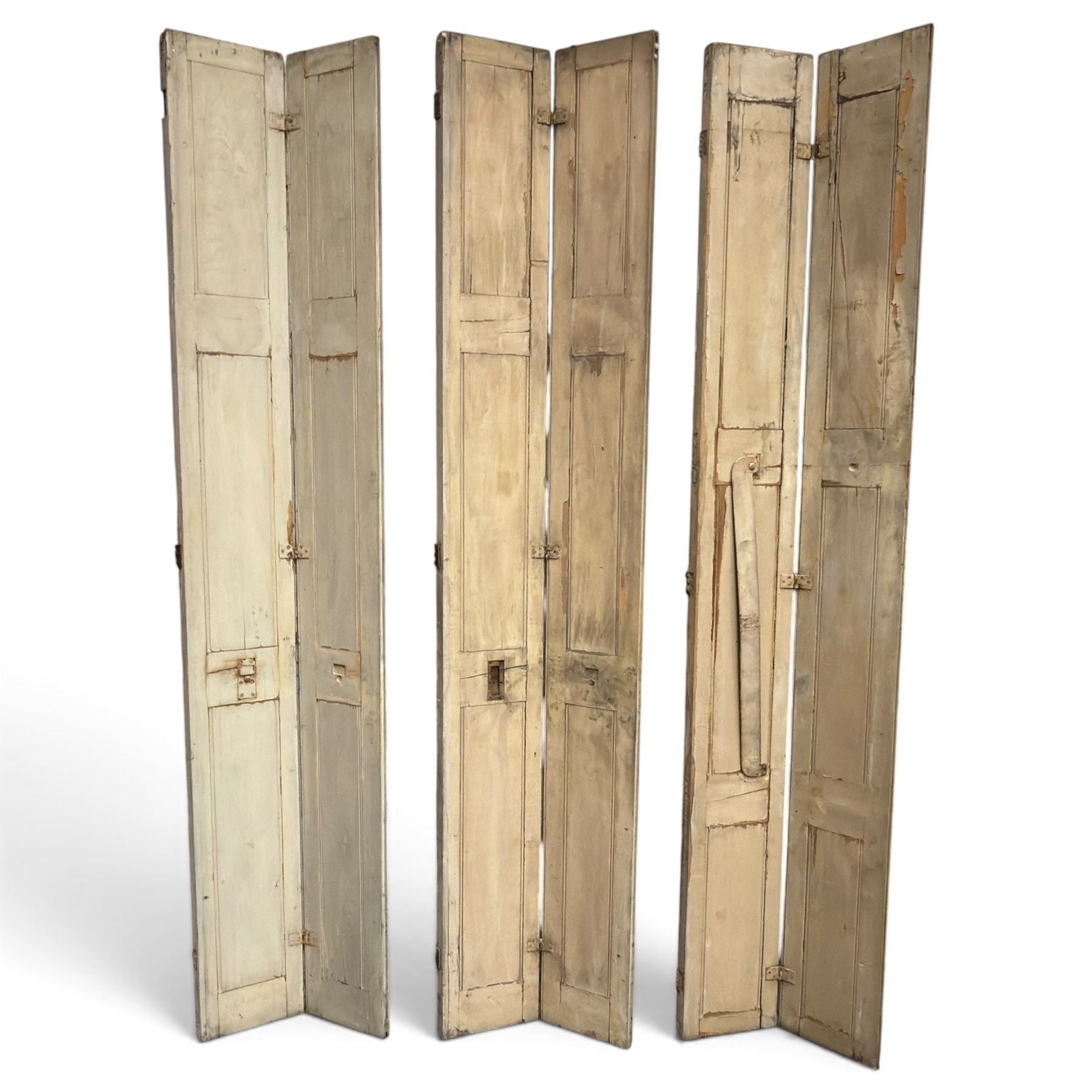 Set of three French 19th century painted pine folding window shutters of tall form, each comprising two hinged leaves with three graduated raised and fielded panels, in antique cream-painted finish