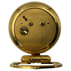 Cartier, Pasha de Cartier desk/travel clock, of circular form with gilt finish and white dial, with quartz movement, inscribed verso Made in France, Cartier Paris, serial no 0541616, dial D5cm, clock H9.7cm