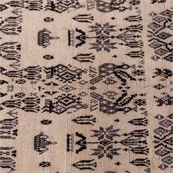 Moroccan hand-knotted Berber rug, of rectangular form, ivory ground woven with horizontal bands of stylized tribal motifs, including abstract animals and anthropomorphic figures, interspersed with geometric devices, with fringe ends 