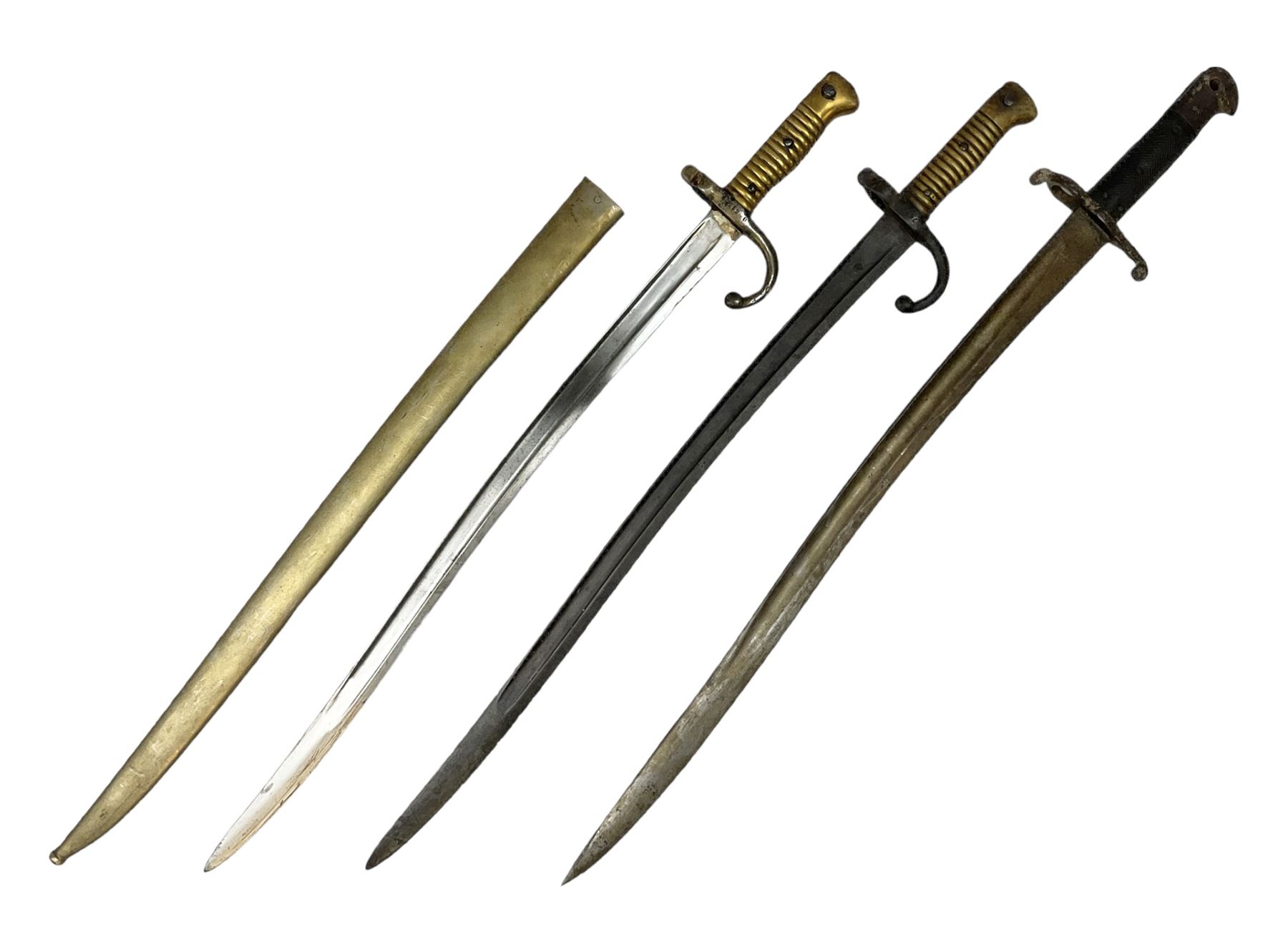 French Model 1866 sabre bayonet with 57cm fullered steel curving blade; in steel scabbard L71cm overall; another Model 1866 sabre bayonet lacking scabbard; and British Pattern 1856 sword bayonet (no scabbard) (3)