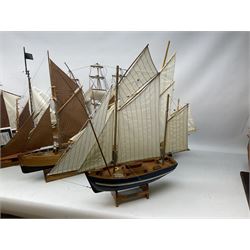 Eight model ships or boats including fishing boat with fish, nets and buoyancy aid, two mast sailing ship complete with cannons, two mast yacht with detailed rigging and life boat etc, the largest L72cm, H60cm