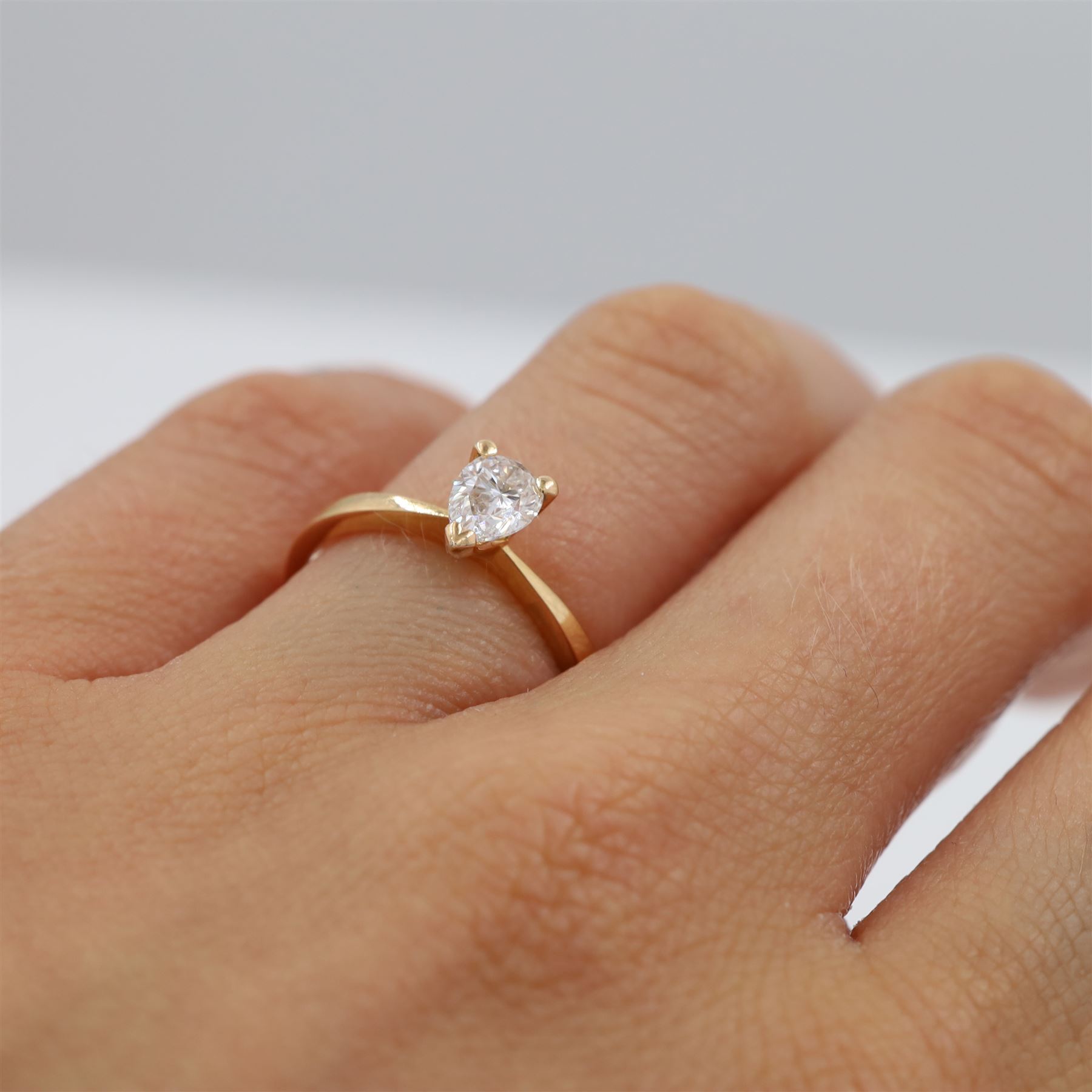 18ct rose gold diamond ring, three claw set with a single pear cut diamond of 0.52 carat, hallmarked, boxed with with GIA report
