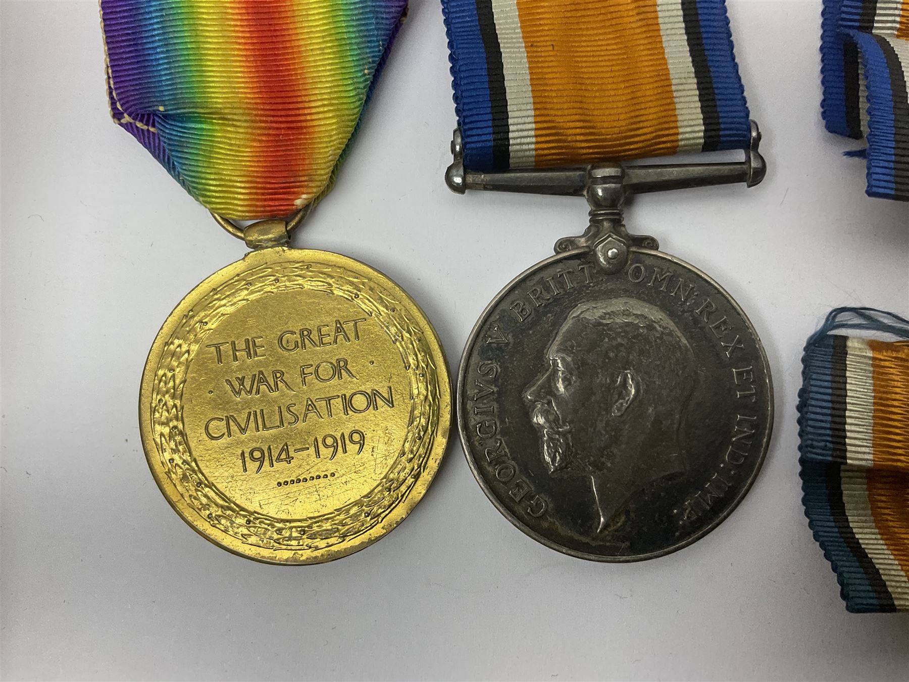WWI pair of medals comprising British War Medal and Victory Medal awarded to 32682 Pte. W. Meadows W. Rid. R. in issue box; WWI pair of medals comprising 1914-15 Star and Victory Medal awarded to 3720 Pte. (later Cpl.) E. Petty W. York. R. with issue letter from Tank Corps; WWII group of five medals comprising 1939-45 War Medal, Defence Medal and 1939-45, Italy and Africa Stars; all with ribbons; and book of nineteen seaman's Certificates of Discharge to cook Charles Filburn 1893 - 1901 from various British ports