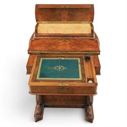 Victorian burr walnut Davenport, with hinged stationary top and slope, pull out writing surface with tooled green leather inset top, carved and turned front supports, flanked by two cupboard doors, raised on castors 
